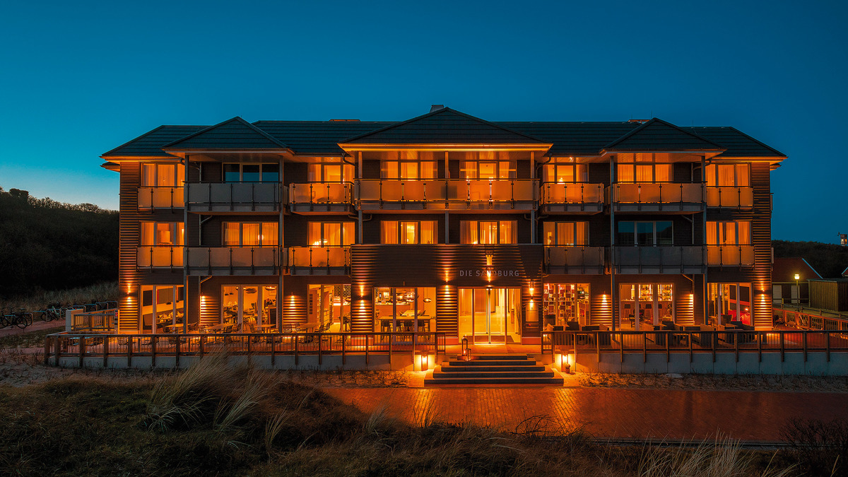The symmetrical facade with its terrace, porches and pagoda-like roofs looks like a typical, German oceanside resort on a boardwalk.